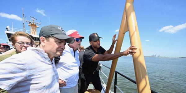 Quigley looks out at the ocean with Governor Wes Moore and other members of Congress