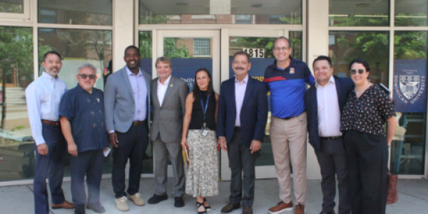 Rep Quigley stands in a row with Rep. Garcia and representatives of the organizations he met with in Pilsen