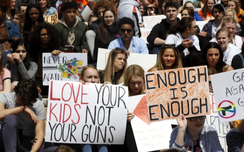 students hold anti-gun protest signs
