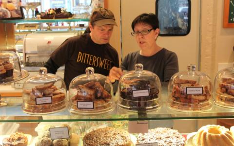 Rep. Quigley learns about all the details that go into running a successful small business by Judy Contino, owner of Bittersweet Pastry Shop.