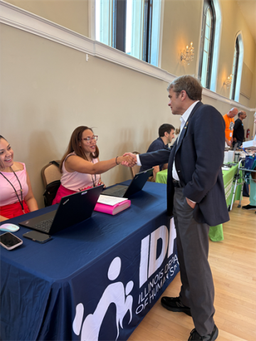 Mike Quigley interacting with booths at his community resource fair