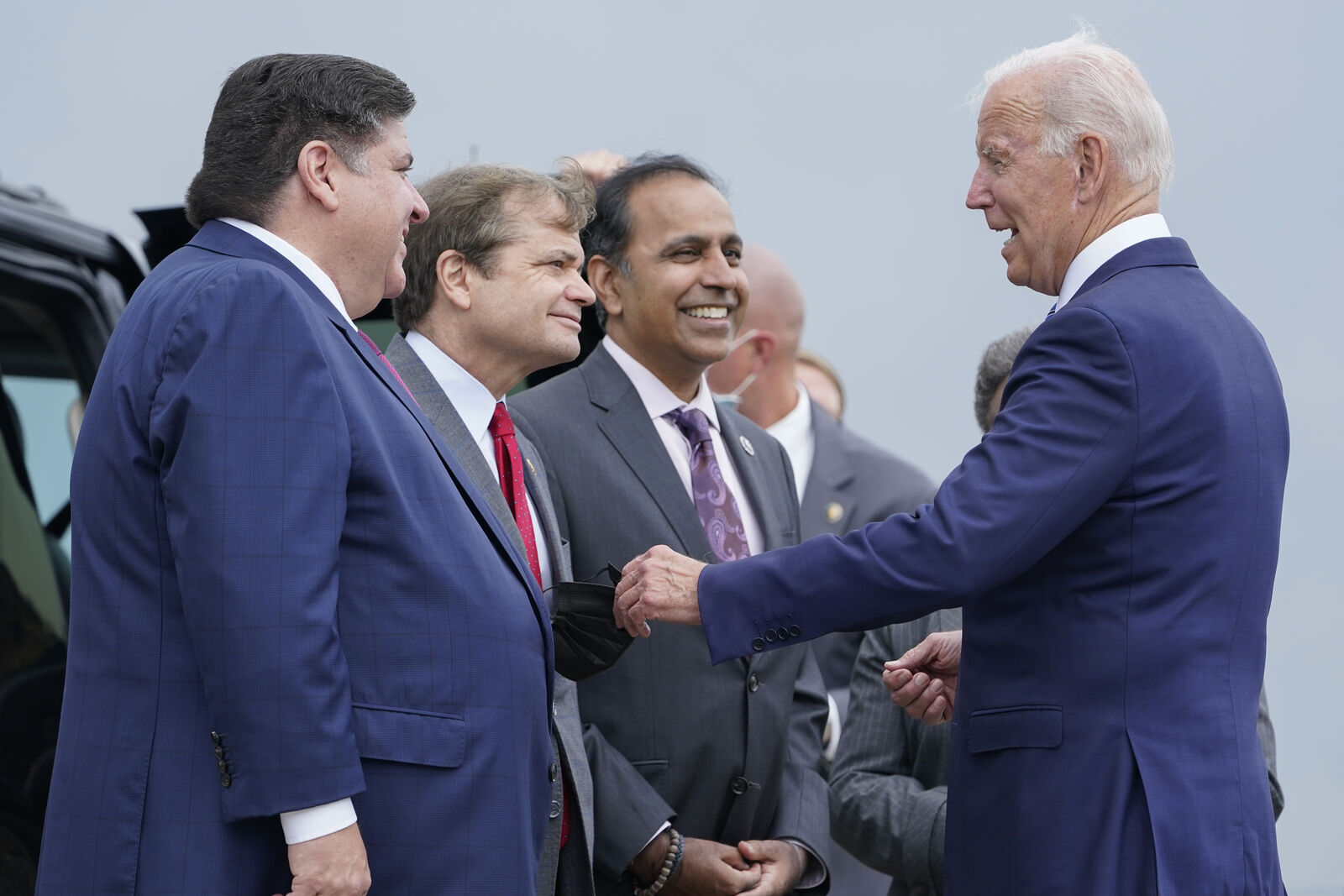 President Biden greets Congressman Mike Quigley and Governor Pritzker