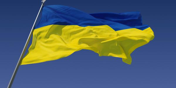 The Ukraine flag against a blue sky