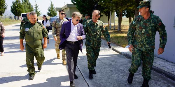 Mike Quigley walks with members of the Albanian military during a visit to Albania