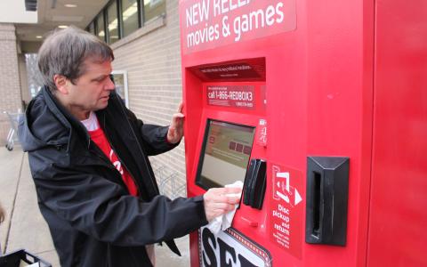 Rep. Quigley cleaned the exterior of a Redbox machine in Villa Park, Illinois.