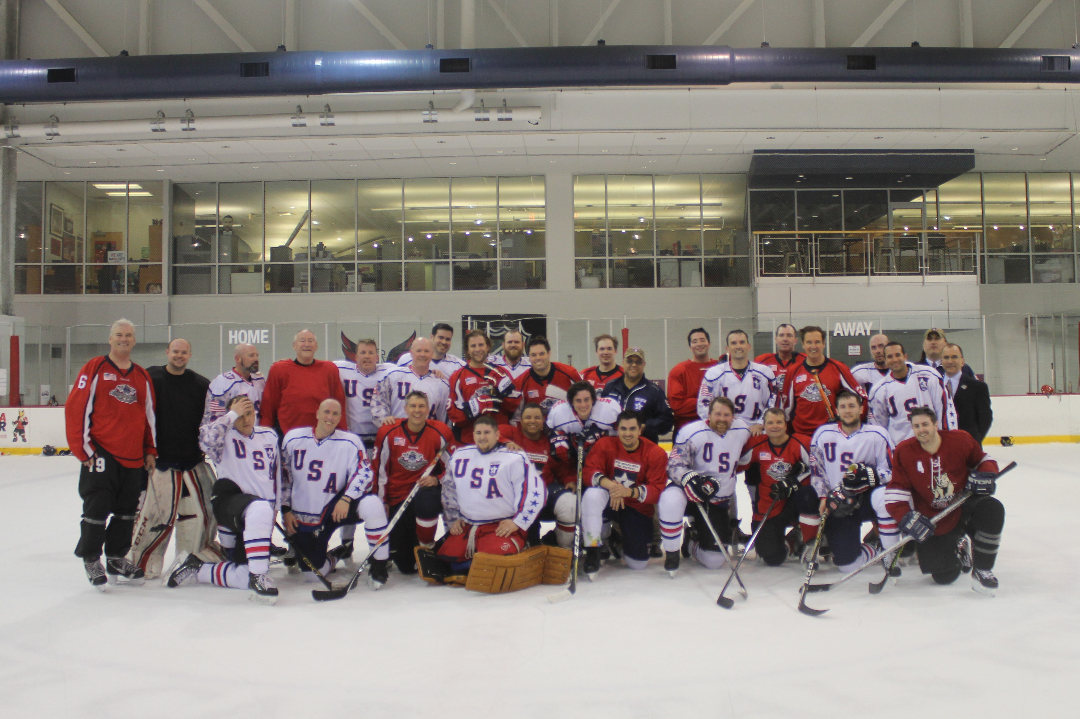 Rep. Mike Quigley poses with the USA Warriors hockey team after a match.